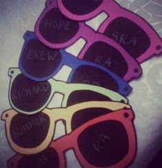 five pairs of sunglasses with words on them