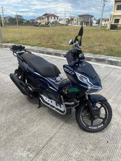 a blue motorcycle parked on the side of a road