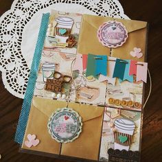 a close up of an open envelope on a table with doily and paper decorations