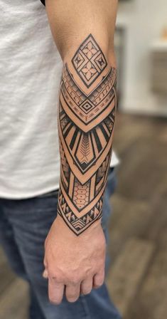 a man's arm with a tattoo on it and a geometric design in the middle