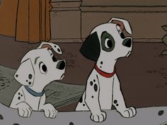 two dalmatian dogs sitting next to each other