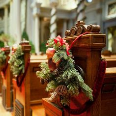 christmas wreaths and pine cones on the pews of a church