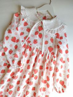 This girl's dress is made from soft muslin fabric adorned with a charming strawberry pattern. The lightweight material is perfect for warm weather, providing both comfort and breathability. The cute strawberry design adds a touch of sweetness, making it an ideal choice for any casual outing or special occasion. Measurements: 5 year old Height: 65 cm Arm: 40 cm Chest (single width): 34 cm Please note the measurements provided. Please handle with care when washing. Cute White Dress With Strawberry Print, Cute Cotton Swiss Dot Dresses, Cute Swiss Dot Cotton Dress, Sweet Cotton Dress With Strawberry Print, Pink Cotton Dress With Strawberry Print, Sweet Pink Strawberry Print Dress, Sweet Cotton Dress With Doll Collar, Sweet Red Long Sleeve Dress, Muslin Dress