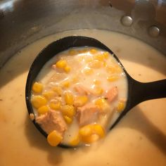 a pan filled with soup and corn on the side