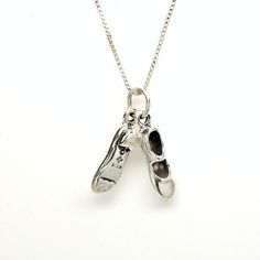 a silver necklace with two pairs of shoes hanging from it