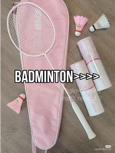 the badminton racket is laying on the floor next to other accessories and items that have been placed around it