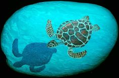 a painting of two sea turtles on a rock