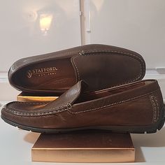 Take Hold Of A Truly Timeless And Versatile Loafer With Stafford Comfort Loafers. This Expertly Crafted Shoe Features Moccasin-Toe Stitching On The Leather Upper, Dual Elastic Puncturing, Allowing For Easy On/Off, A Soft Insole, And Genuine Welt Construction For Superior Comfort Throughout Your Day. The Flexible Polyurethane Sole Offers The Highest Degree Of Shock Absorption. - 100% Vegan Leather - Polyurethane Cushioning Outsole 3/4" Comfort Heel - Shock-Absorbing Poron Insole - Whip-Stitching Brown Casual Moc Toe Dress Shoes, Masculine Brown Plain Toe Slip-ons, Brown Ortholite Insole Moccasins For Business, Casual Slip-on Dress Shoes With Ortholite Insole, Casual Business Moccasins With Ortholite Insole, Casual Brown Slip-on Dress Shoes, Business Casual Brown Moccasins With Cushioned Footbed, Brown Moccasins With Cushioned Footbed For Business Casual, Brown Cushioned Moccasins For Business Casual