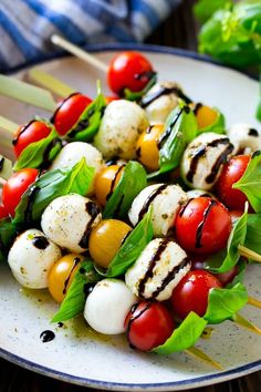 a white plate topped with skewers filled with veggies