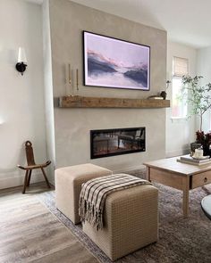 a living room with a couch, coffee table and fire place in the middle of it