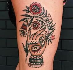 a close up of a person's leg with a tattoo on it and flowers