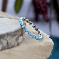 TITLE: -  Blue Turquoise Ring, Delicate Full Eternity Band Ring, 925 Sterling Silver Healing Crystal Jewelry, Stacking Ring for Women SPECIFICATIONS: - ❖ Metal:  925 Solid sterling silver ❖ Gemstone: Turquoise  ❖ Gemstone Size: 2 mm ❖ Gemstone Shape: Round ❖ Total Weight: 1 Gram ❖ Gemstone Setting: Bezel    Note: Our use of natural stones may result in slight variations in texture and color in the actual product you receive, but the quality and grade of the stone remain consistent. FEATURES: -   * This delicate silver ring features a row of vibrant turquoise stones, perfectly set in a simple yet elegant band. The bright blue hue of the turquoise adds a pop of color, making this ring a versatile accessory for any outfit. Ideal for stacking or wearing on its own, it offers a subtle touch of Delicate Silver Rings, Dainty Promise Ring, Jewelry Stacking, Healing Crystal Jewelry, Ring Dainty, Unique Gemstones, Turquoise Gemstone, Ring For Women, Promise Ring