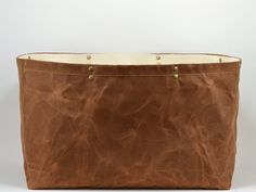 a brown leather bag sitting on top of a white table