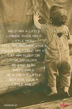 a little boy that is standing next to a rock