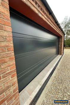 the side of a brick building with a garage door