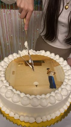 a person cutting into a cake with a knife