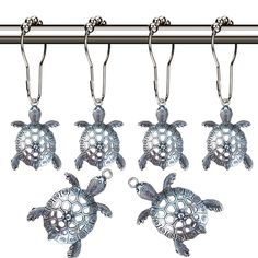 six sea turtle key chains hanging on a bar