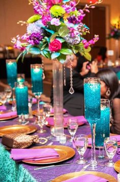 the table is set with purple and blue decorations