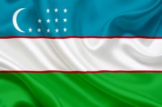 the flag of uzbekistan is waving in the wind