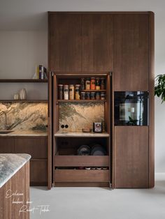 a kitchen with wooden cabinets and marble counter tops