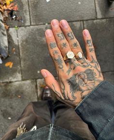 a person with tattoos on their hands and fingers