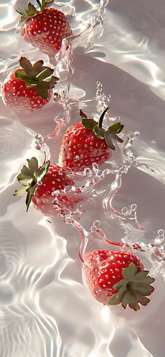 three strawberries are floating in the water