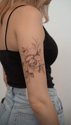 a woman with a flower tattoo on her arm