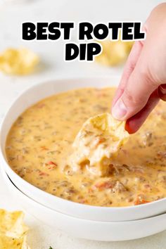 a hand dipping a tortilla chip into a bowl of quesadilla dip