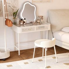 a white vanity table with a mirror and stool next to it in a living room