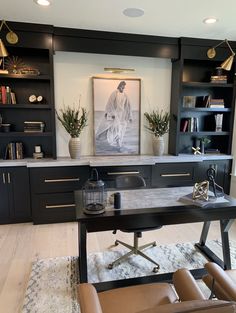 an office with built in bookcases and leather chairs