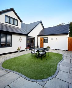 a house with a lawn and patio area