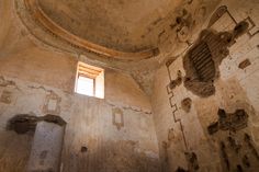 the interior of an old building with stone walls and exposed plasterwork on the ceiling