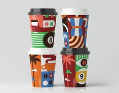 three coffee cups with different designs on them