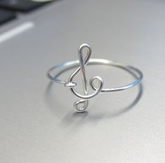 This is my signature sterling silver treble clef ring. I wire wrapped to create this beautiful music ring. Your ring will be custom made to your requested size. The design is very dainty, elegant, simple and smooth. Please email me the ring size you want. Material: 0.925 sterling silver. I also have 14k gold filled and rose gold filled rings available. Please check my other listings for the details. 18 gauge is 1.02 mm thick and 20 gauge is 0.81 mm thick. It comes with a pretty gift box. Treble Clef Ring, Music Ring, Music Note Ring, Music Rings, Best Friend Rings, Friend Rings, Wire Wrapped Jewelry Tutorials, Aluminum Jewelry, Music Jewelry