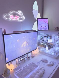 two computer monitors sitting on top of a desk next to a keyboard and monitor screen