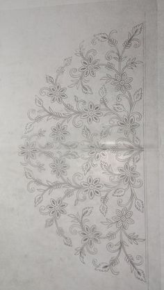 a white wall with an intricate design on it