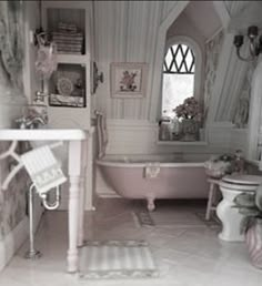 an old fashioned bathroom is shown in black and white, with pink accents on the walls