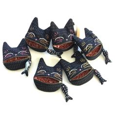 five black cats with red and blue designs on them