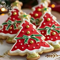 three decorated christmas cookies sitting on top of a plate