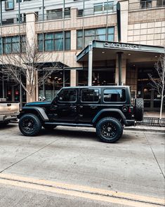 a black jeep parked in front of a building