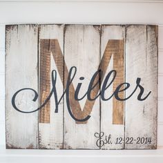 a wooden sign that says miller on it with the letter m in cursive font