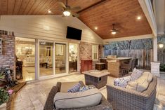 an outdoor living area with patio furniture and ceiling fans