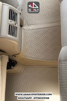 the interior of a car with beige carpet and tan leather seats, including an air conditioner