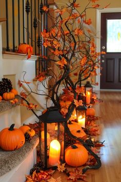 a decorated staircase with candles and pumpkins