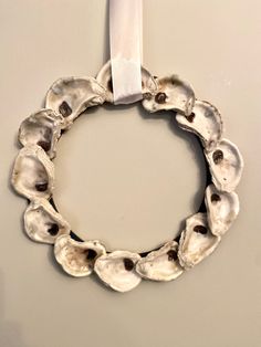 a wreath made out of oysters hangs on the wall