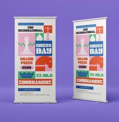 two roll - up banners with the words chess day on them against a purple background