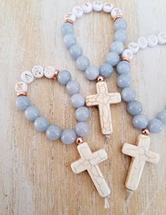 A spin on my original and popular finger rosary, these now come personalized by popular demand and available in rose gold, gold, bronze silver and gunmetal  If you have an special requests or want a combination of metals, stones, names etc please message me.  These rosaries are bulk discounted, please select qty from drop down menu. Please message me names or add them into the comment box upon checkout Adjustable Rose Gold Spiritual Rosary, Personalized Cross Rosary Bracelet For Baptism, Adjustable Rose Gold Rosary As Gift, Spiritual Rose Gold Rosary Bracelet Gift, Handmade Spiritual Jewelry For Confirmation, Personalized Rosary With Round Beads As Gift, Personalized Spiritual Rosary Gift, Personalized Spiritual Rosary As Gift, Spiritual Cross Rosary Bracelet For Baptism