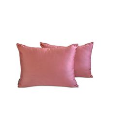 two pink pillows sitting next to each other