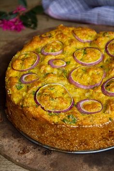 an omelet with onions on a wooden cutting board