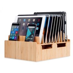 a wooden cell phone holder with six phones in it and one on the other side